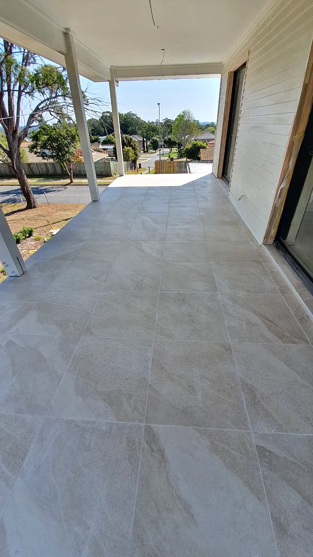 Covered patio tiled with large-format light tiles