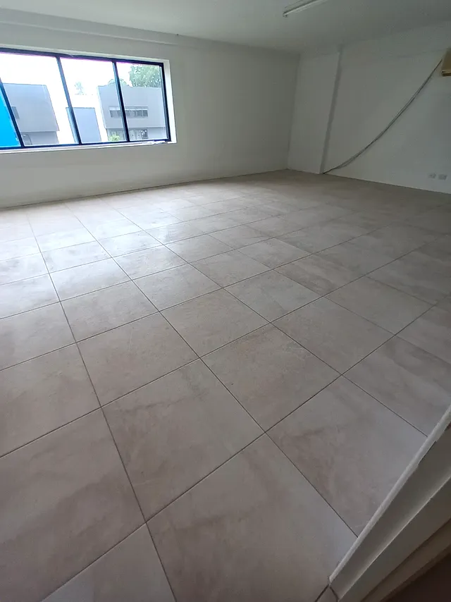 Room with light large-format floor tiles