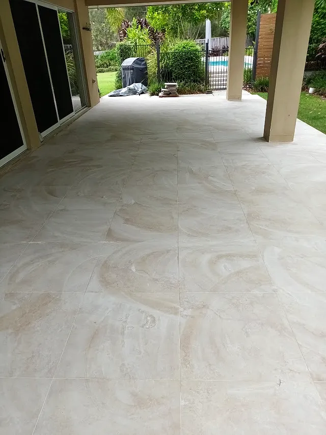 Covered alfresco with light polished floor tiles looking onto the garden