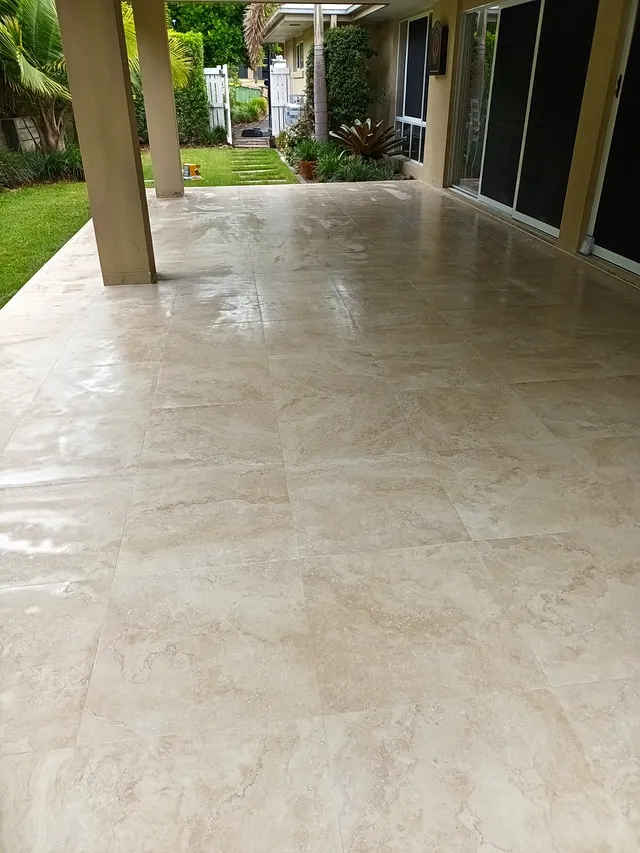 Alfresco floor tiled with polished light tiles under a covered area