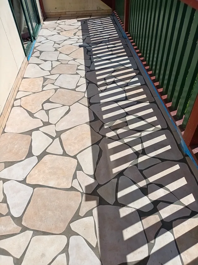Close-up of crazy-paving style tiles on a balcony
