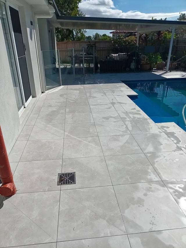 Tiled pool surround running into a covered patio