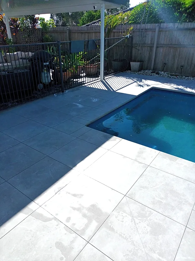Pool and spa surrounded by grey porcelain tiles
