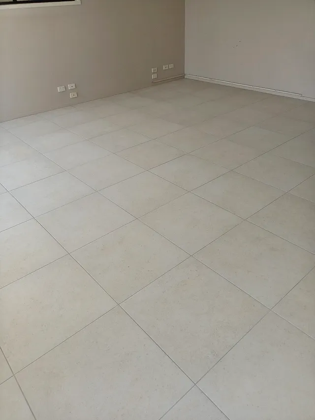 Open room with light large-format floor tiles