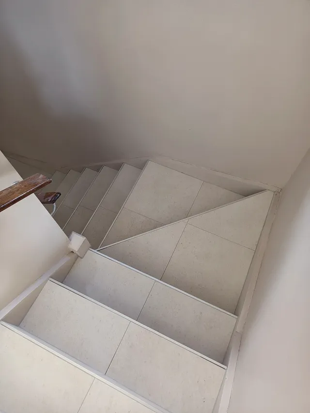 Tiled stairs turning at a landing