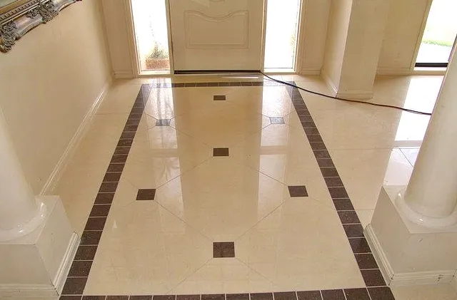 Polished entry floor with a dark inlay border and squares