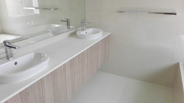 Bathroom with a double basin vanity and large mirror